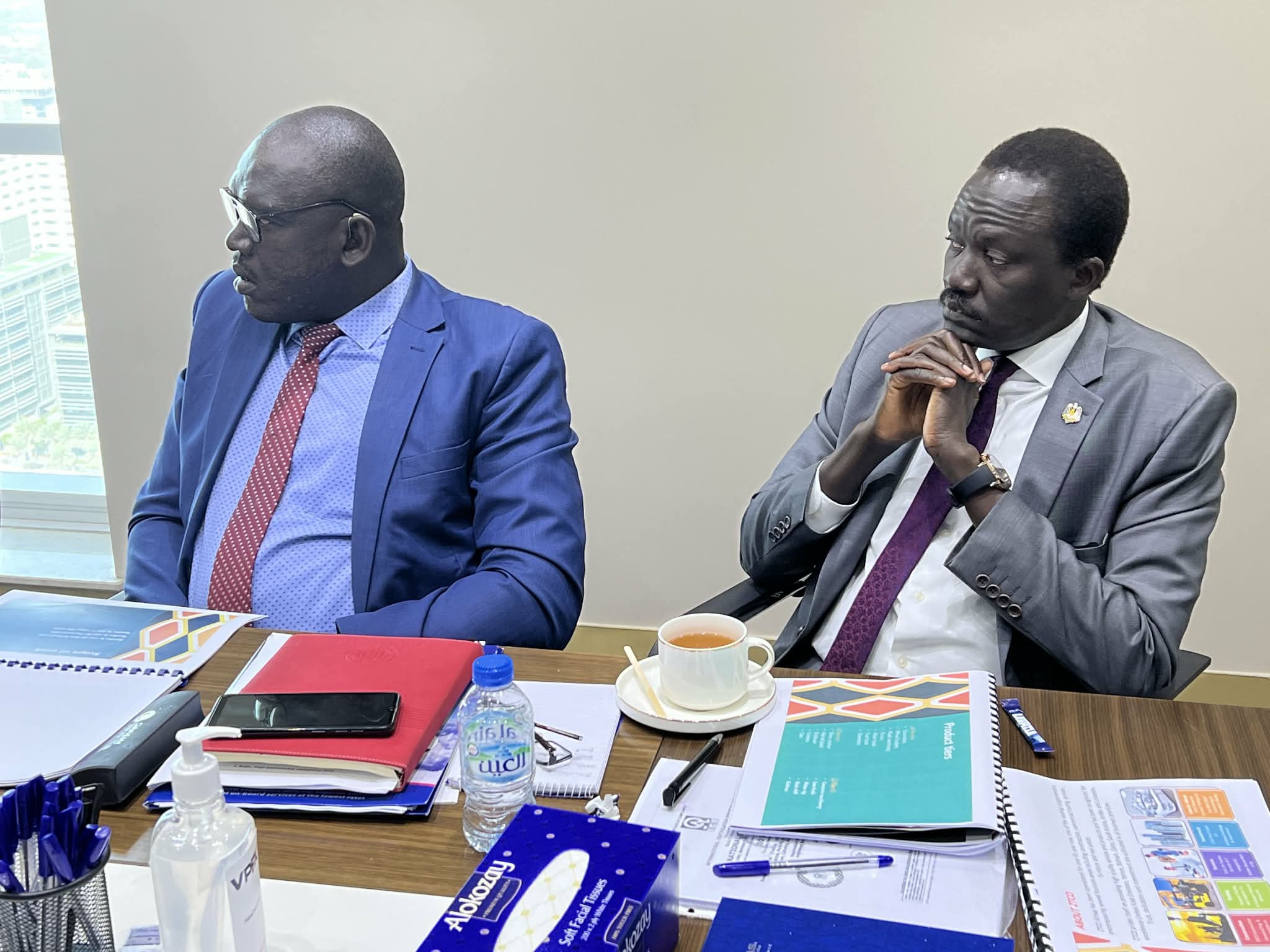 Two participants listening during a meeting.